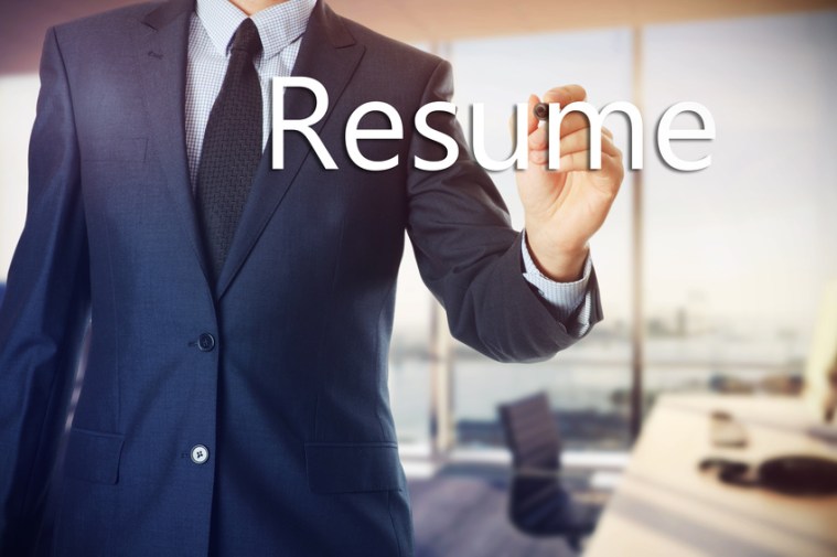 the businessman in the office is writing on the transparent board : resume